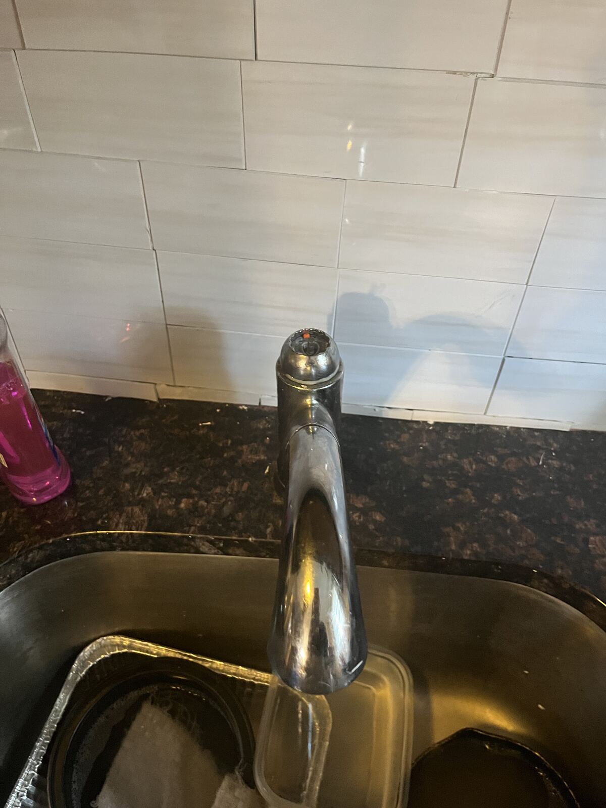 Chrome faucet mounted over a sink