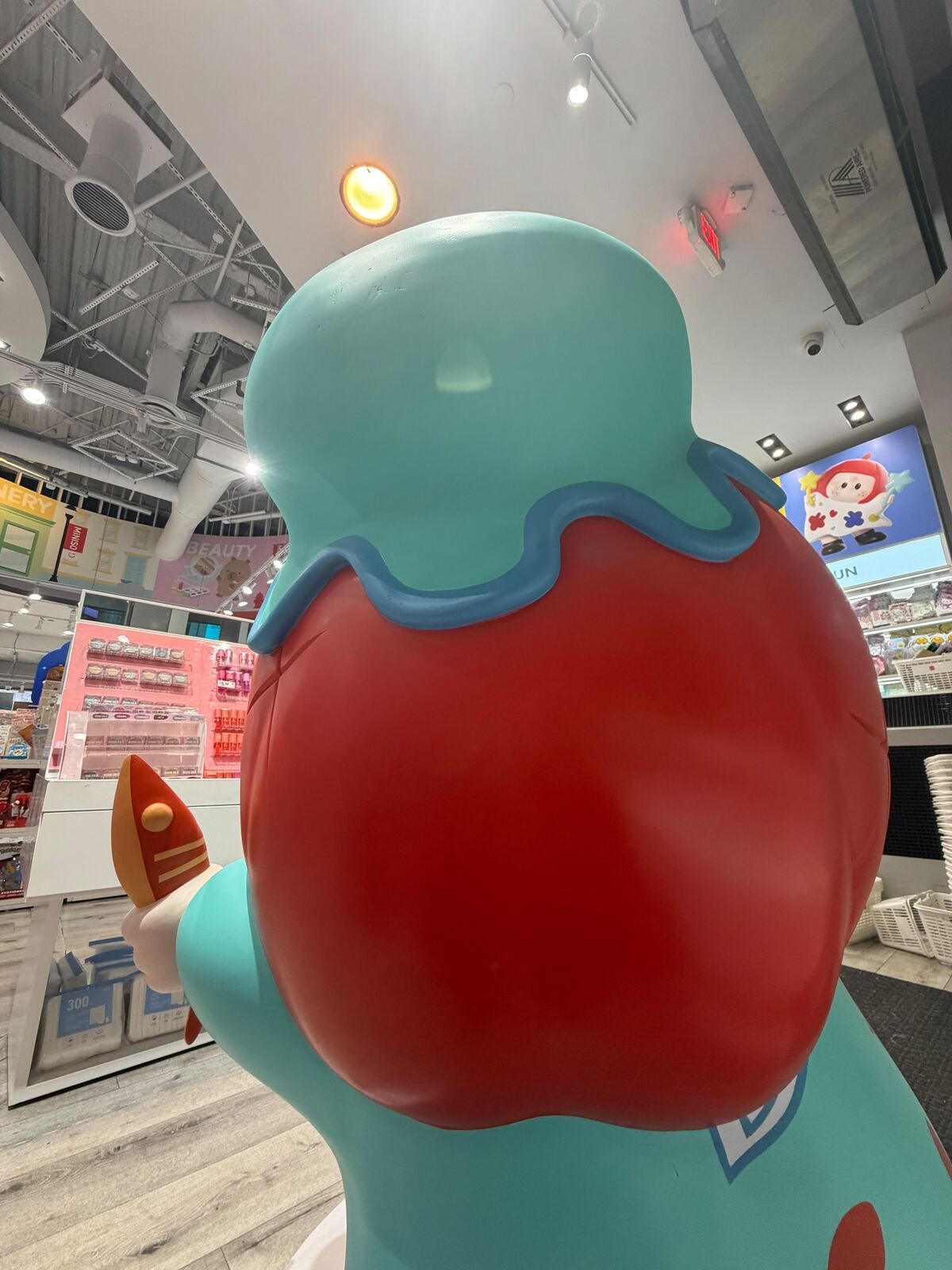 Teal and red fiberglass mascot statue after surface repair and refinishing