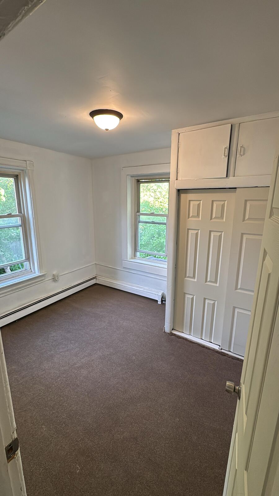 Cleared bedroom with light walls and carpet after a turnover