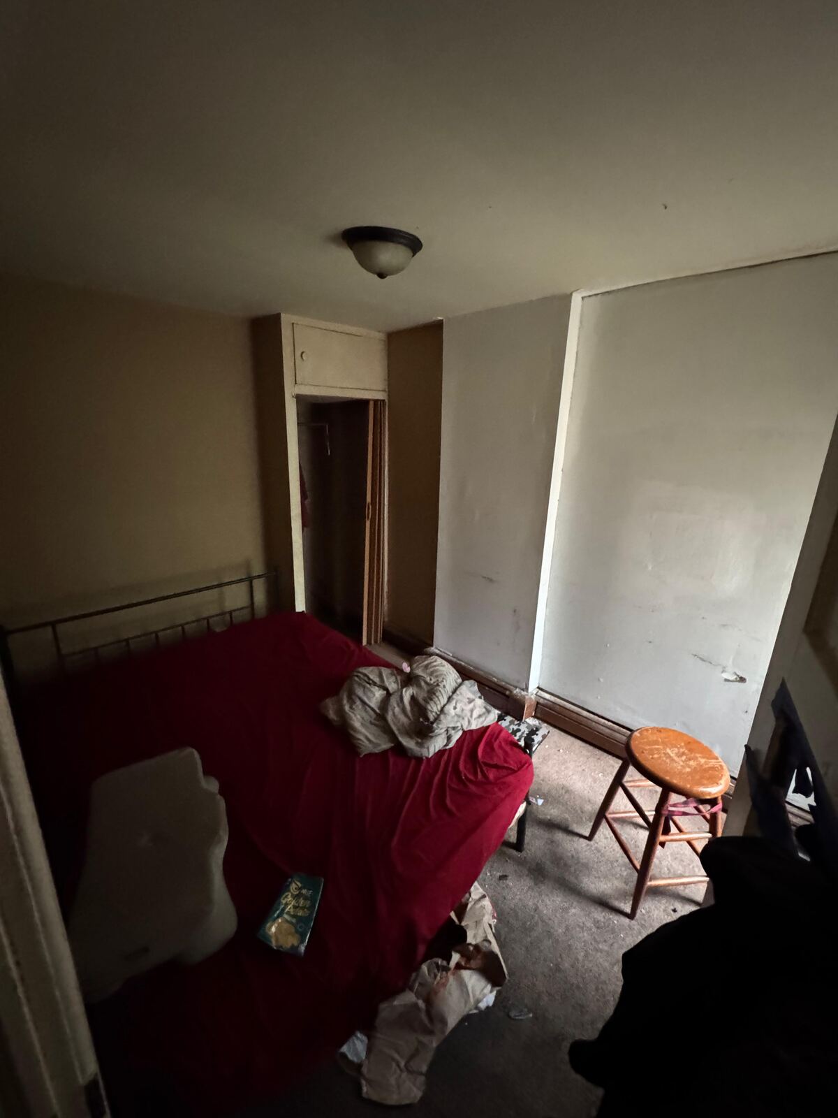Bedroom with furniture and personal items before a turnover
